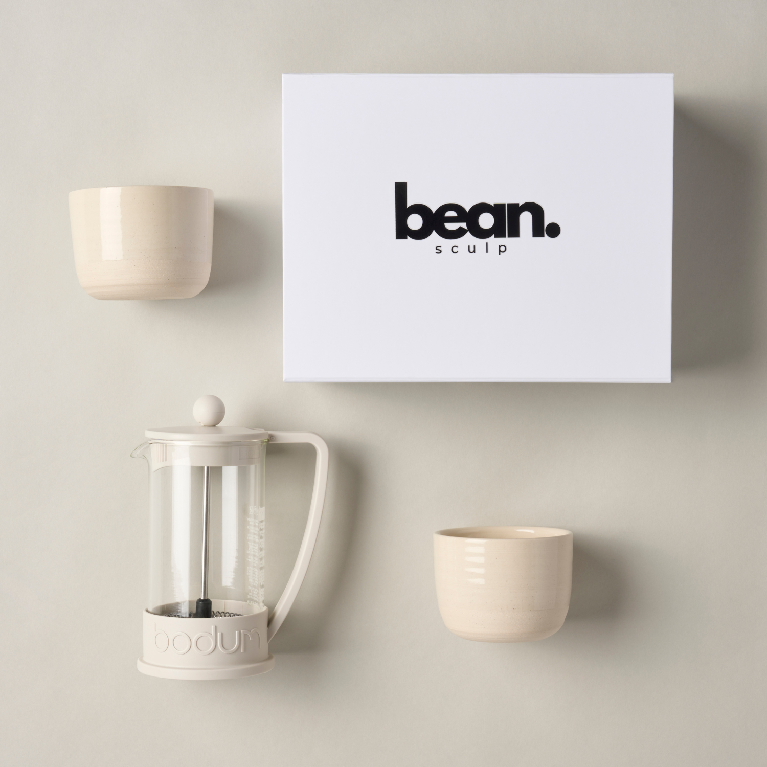 Flat-lay of the French Press Coffee Bundle: two stoneware flat white tumblers and a 3-cup French press coffee maker on a white surface, ready for brewing.